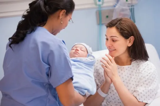 Nurse handing over newborn baby 