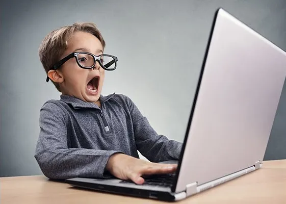 Shocked kid on computer 