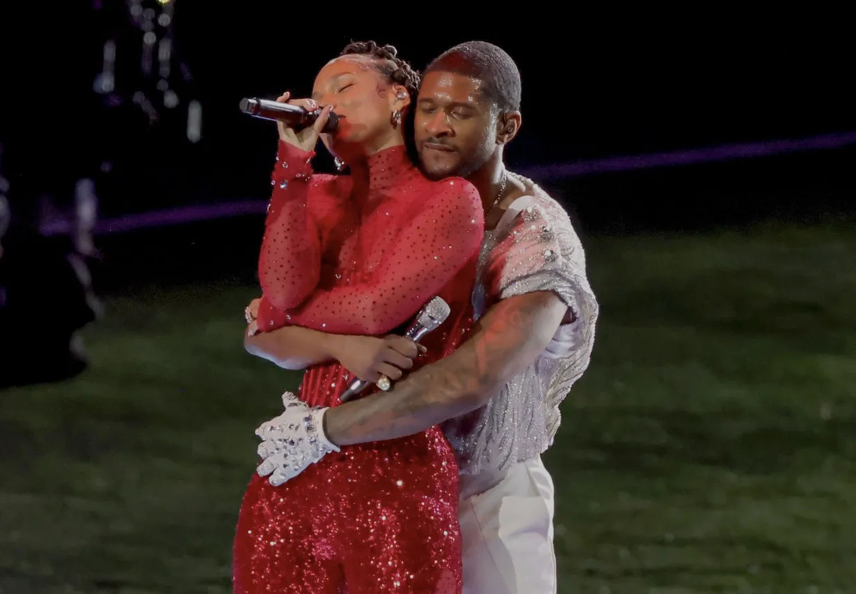 Usher hugging Keys