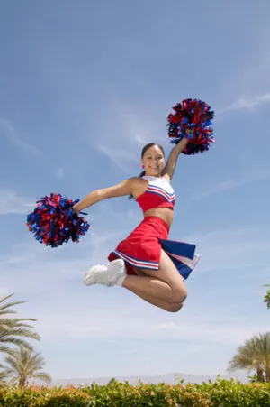 cheerleader jump with pom poms 