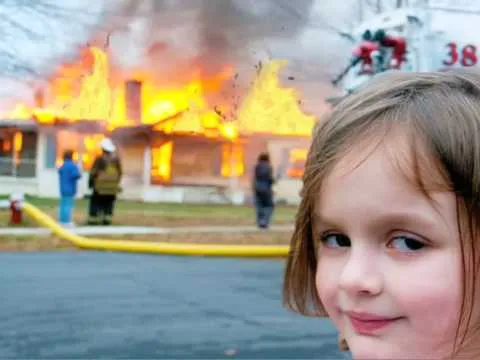 girl smiling with house burning 