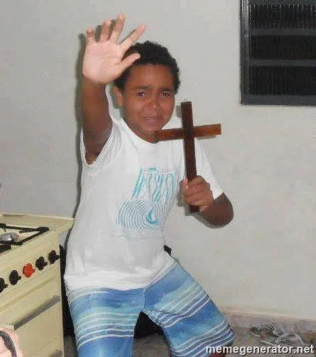 scared kid holding a cross 