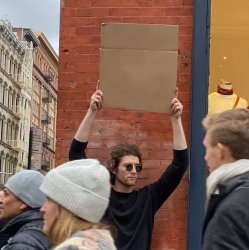 Man Holding Up Sign